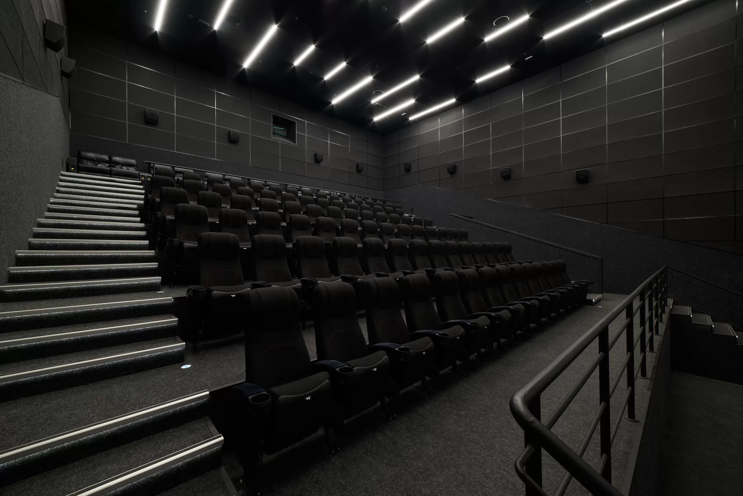 Empty cinema hall with black seats. Movie theatre nobody